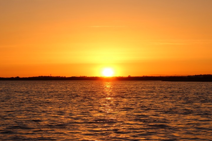 a sunset over a body of water