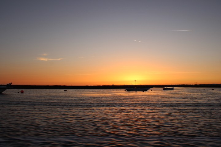 a sunset over a body of water