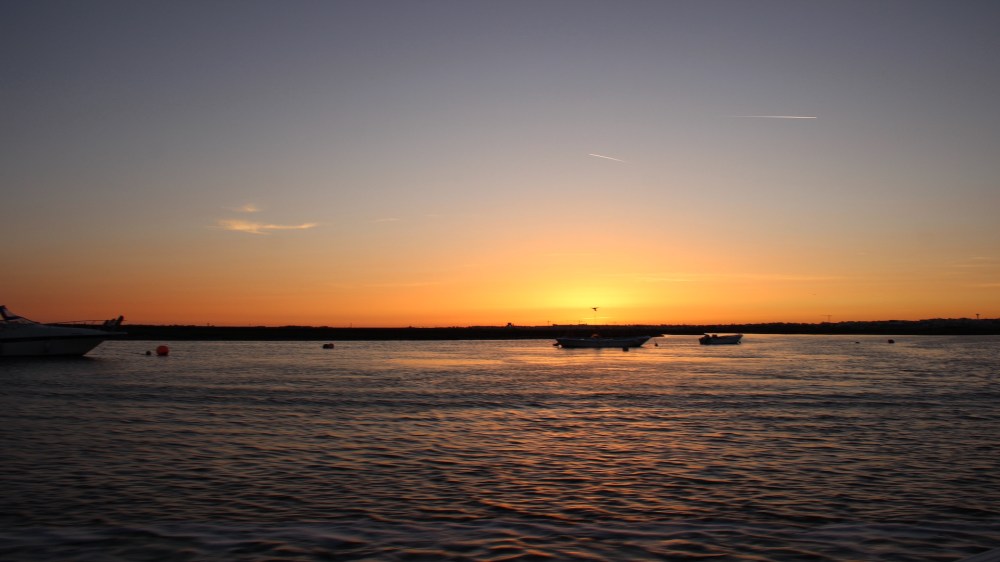 Sunset over the water and boats
